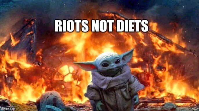 This meme is a humorous image featuring a character from the Star Wars franchise, Baby Yoda, standing in front of a burning cityscape. The text "Riots not diets" is superimposed over the image, implying that the destruction and chaos of a riot is a more effective way to lose weight than following a diet.